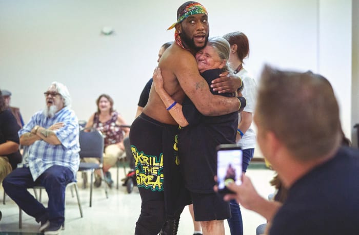 Skrilla the Great embraces a fan.